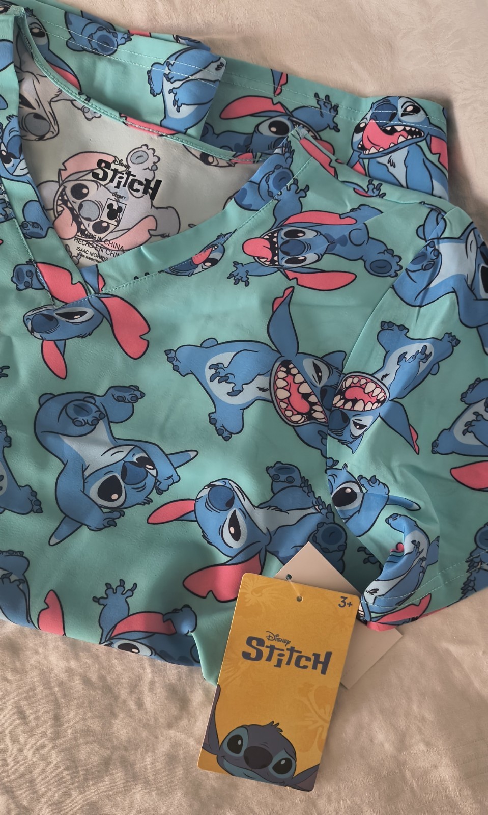 DISNEY Women’s Size S Stitch Graphic Scrub Top V-Neck Front Pockets • Turquoise