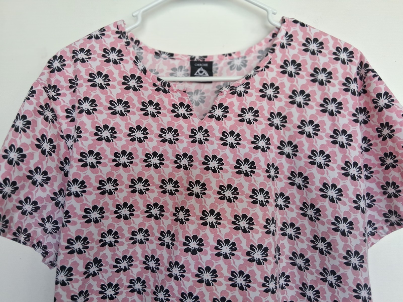 Cherokee sz L scrub top in pink w/ black white floral print, back tie. Very good