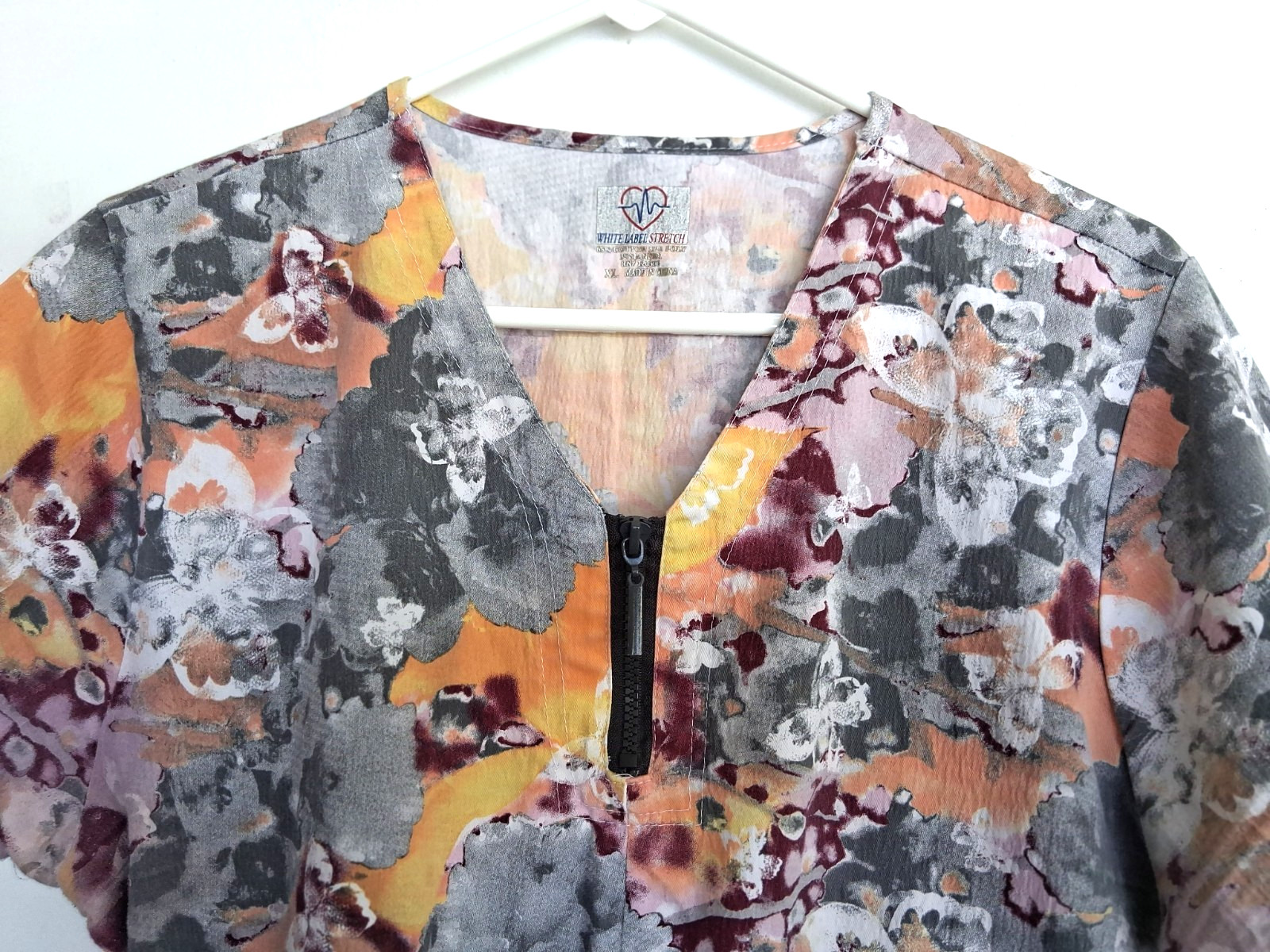 Size XL scrub top in multi colors w/ butterflies. Excellent condition
